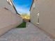Small grassy backyard with brick pavers and a gate at 27486 N 89Th Dr, Peoria, AZ 85383