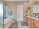 Elegant bathroom with double vanity and soaking tub at 27486 N 89Th Dr, Peoria, AZ 85383