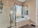 Bathroom with walk-in shower and soaking tub at 27486 N 89Th Dr, Peoria, AZ 85383