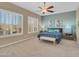 Main bedroom with a ceiling fan and large windows at 27486 N 89Th Dr, Peoria, AZ 85383