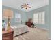 Spacious bedroom with ceiling fan and large windows at 27486 N 89Th Dr, Peoria, AZ 85383