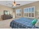 Bedroom with ceiling fan, large windows, and ample closet space at 27486 N 89Th Dr, Peoria, AZ 85383