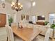 Bright dining room features a wood table, chandelier, and high ceilings at 27486 N 89Th Dr, Peoria, AZ 85383