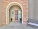 Elegant entryway with arched stone accents and security door at 27486 N 89Th Dr, Peoria, AZ 85383