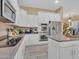 Modern kitchen featuring white cabinetry, stainless steel appliances, and a large island at 27486 N 89Th Dr, Peoria, AZ 85383