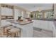 Spacious kitchen with an island, white cabinets, and a view into the Gathering room at 27486 N 89Th Dr, Peoria, AZ 85383