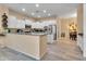 Modern kitchen with white cabinets and a large island at 27486 N 89Th Dr, Peoria, AZ 85383