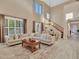 Large living room with a sectional sofa and high ceilings at 27486 N 89Th Dr, Peoria, AZ 85383