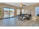 Living room with sliding doors opening to a pool and backyard at 27486 N 89Th Dr, Peoria, AZ 85383