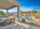 Relaxing backyard with covered patio, pool, and fire pit at 27486 N 89Th Dr, Peoria, AZ 85383