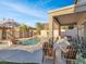 Serene backyard with pool, patio furniture, and mountain views at 27486 N 89Th Dr, Peoria, AZ 85383