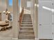 Elegant staircase with carpeted steps and wooden railing at 27486 N 89Th Dr, Peoria, AZ 85383
