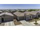 Wide aerial shot of a single-story home with a tiled roof in a community with similar desert-landscaped homes at 40015 W Crane Dr, Maricopa, AZ 85138