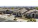 Aerial view of a charming single-story home in a well-maintained residential neighborhood with desert landscaping at 40015 W Crane Dr, Maricopa, AZ 85138
