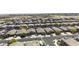 An aerial view showcases a well-maintained community with uniform houses, landscaping, and street layout at 40015 W Crane Dr, Maricopa, AZ 85138