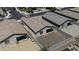 An aerial view of a backyard featuring a gravel area, block wall, and exterior of the home at 40015 W Crane Dr, Maricopa, AZ 85138
