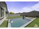 Backyard featuring a pool, spa, block fencing and greenery, perfect for relaxation at 40015 W Crane Dr, Maricopa, AZ 85138