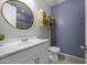 Well-lit bathroom featuring a large vanity, oval mirror, and coordinated decor at 40015 W Crane Dr, Maricopa, AZ 85138