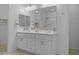 Bright bathroom features double sinks and vanity, tiled floors, and a glass-enclosed shower at 40015 W Crane Dr, Maricopa, AZ 85138