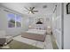 Comfortable bedroom featuring a ceiling fan, natural light, and a modern sliding door at 40015 W Crane Dr, Maricopa, AZ 85138