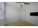 Bright bedroom featuring a ceiling fan, TV, and doorway leading to another room at 40015 W Crane Dr, Maricopa, AZ 85138