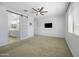Bright bedroom with a barn door entrance to the bathroom and carpeted floors at 40015 W Crane Dr, Maricopa, AZ 85138