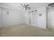 Bright bedroom with a barn door entrance to another room and carpeted floors at 40015 W Crane Dr, Maricopa, AZ 85138