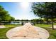 A scenic path leads to a lake surrounded by lush greenery in this community at 40015 W Crane Dr, Maricopa, AZ 85138