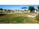 Playground with climbing structure, covered picnic area, and other amenities in a grassy community park at 40015 W Crane Dr, Maricopa, AZ 85138