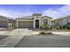 Inviting single-story home with desert landscaping, a two-car garage, and a covered front entry at 40015 W Crane Dr, Maricopa, AZ 85138