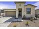 Close-up view of a home's front entrance featuring desert landscaping and an inviting covered entryway at 40015 W Crane Dr, Maricopa, AZ 85138