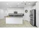 Stylish kitchen with white cabinets, stainless steel appliances, and a functional center island at 40015 W Crane Dr, Maricopa, AZ 85138