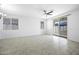Open living area with tiled floors, a ceiling fan, and sliding glass doors to the patio at 40015 W Crane Dr, Maricopa, AZ 85138