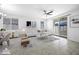 Bright living room features neutral tones, modern decor, and sliding glass doors to backyard at 40015 W Crane Dr, Maricopa, AZ 85138