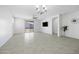 Spacious living room boasts neutral paint, a chandelier, and a ceiling fan at 40015 W Crane Dr, Maricopa, AZ 85138