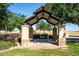 Covered picnic area with stone pillars, a barbecue grill, and a table for outdoor dining and gatherings at 40015 W Crane Dr, Maricopa, AZ 85138