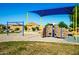 A playground offers a climbing wall, swings, and other fun activities in this Gathering friendly neighborhood at 40015 W Crane Dr, Maricopa, AZ 85138