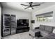 Living room features a grey sectional sofa, large TV, and sliding glass door at 433 W Ivanhoe Pl, Chandler, AZ 85225