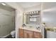 Bathroom featuring an extended vanity, enclosed shower, tiled flooring, with bright lighting and neutral paint at 5525 E Thomas Rd # N1, Phoenix, AZ 85018