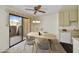 Bright dining area featuring a sliding glass door to a private patio with a modern light fixture and neutral walls at 5525 E Thomas Rd # N1, Phoenix, AZ 85018