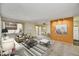 Spacious living room with an accent wall flowing into the dining area featuring neutral tones and natural light at 5525 E Thomas Rd # N1, Phoenix, AZ 85018