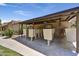 Mailboxes enclosed in a shaded structure with manicured grass, surrounded by desert landscaping and tan condos at 5525 E Thomas Rd # N1, Phoenix, AZ 85018