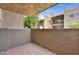 Private patio with a stucco wall providing additional privacy with desert landscaping and a view of nearby condos at 5525 E Thomas Rd # N1, Phoenix, AZ 85018