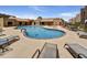 Relaxing community pool with lounge chairs, tables, and mature trees in a resort style atmosphere at 5525 E Thomas Rd # N1, Phoenix, AZ 85018