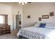 This cozy bedroom has neutral tones and a large dresser, with a peek into an adjoining room at 8598 E Saguaro Blossom Rd, Gold Canyon, AZ 85118