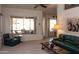 Bright living room with comfortable seating, neutral carpet, and an open view to the outdoor patio at 8598 E Saguaro Blossom Rd, Gold Canyon, AZ 85118