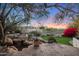 Beautiful backyard at sunset with a pond, grass, and mountain views at 1535 E Calavar Dr, Phoenix, AZ 85022