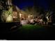 Landscaped backyard at night with lighting and a water feature at 1535 E Calavar Dr, Phoenix, AZ 85022