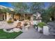 Landscaped backyard oasis with a waterfall and seating area at 1535 E Calavar Dr, Phoenix, AZ 85022