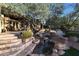 Outdoor space with stone steps, waterfall feature, and lush landscaping at 1535 E Calavar Dr, Phoenix, AZ 85022